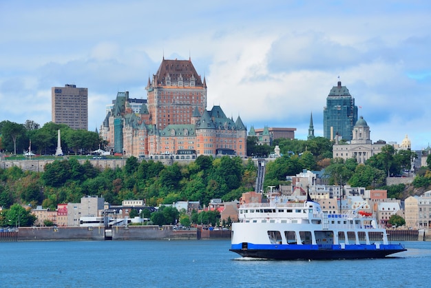 Free photo quebec city skyline over river with blue sky and cloud.