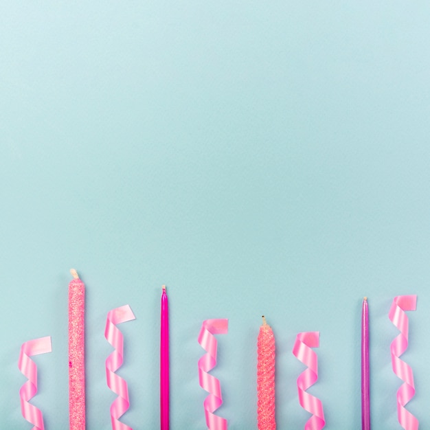 Quinceañera composition on blue background with candles and ribbons