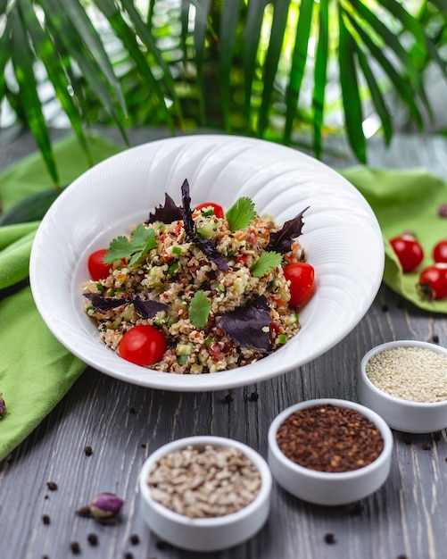 Quinoa salad tomato cucumber basil parsley side view