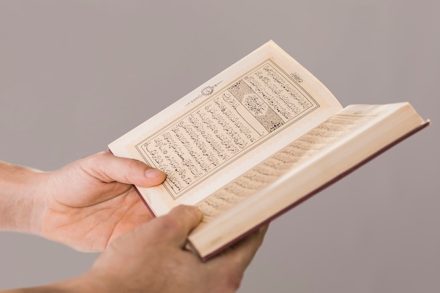 Free photo quran being held in hands close-up