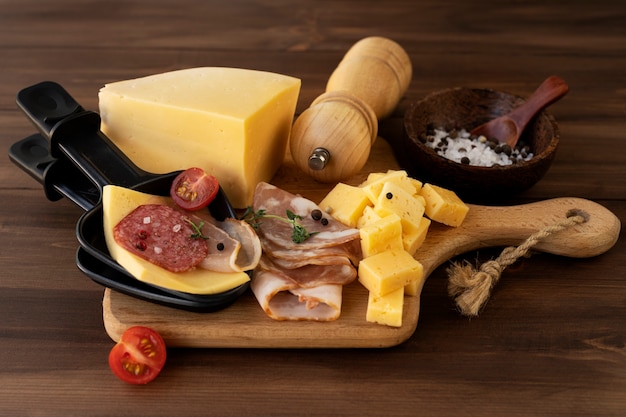 Free photo raclette dish made with cheese and assortment of delicious food