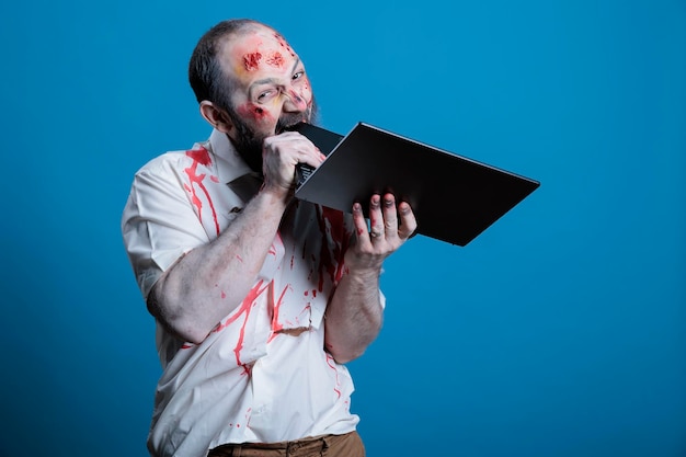 Free photo raging man biting laptop in frustration stressed by job working him to death