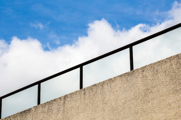 Free photo railing with blue sky and clouds