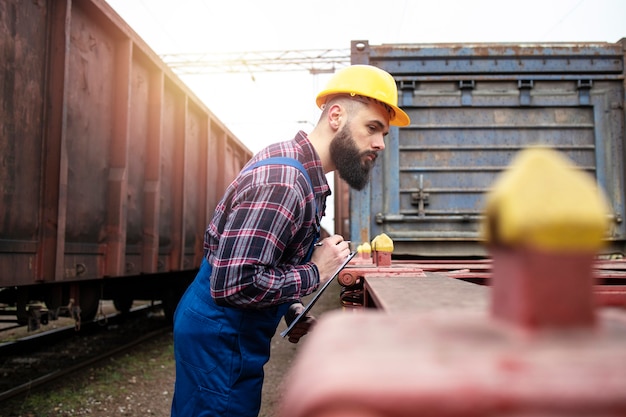 Free Photo railroad worker checking space for shipping cargo container