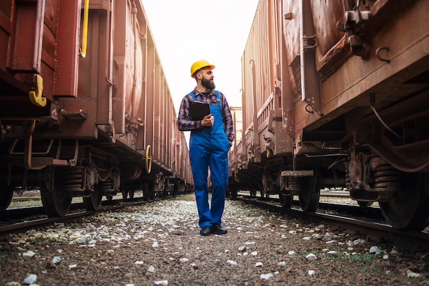 Free photo railway transportation supervisor checking trains and cargo