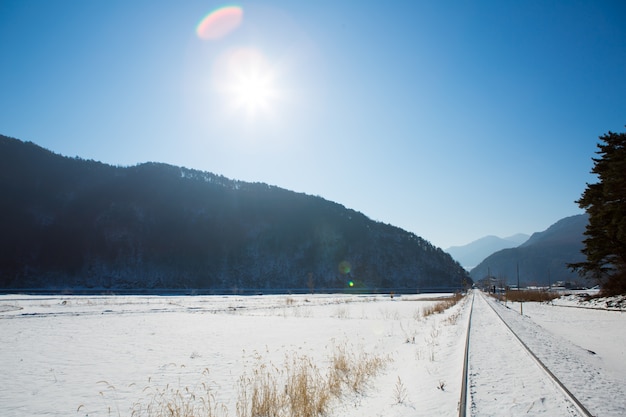 Free photo railway in winter with sun