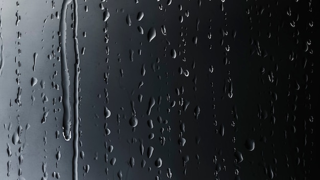 Free photo rain drops on glass black background