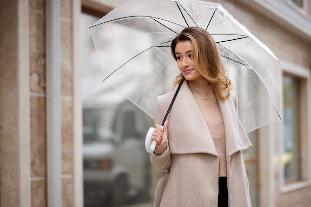 Rain portrait of young beautiful woman with umbrella