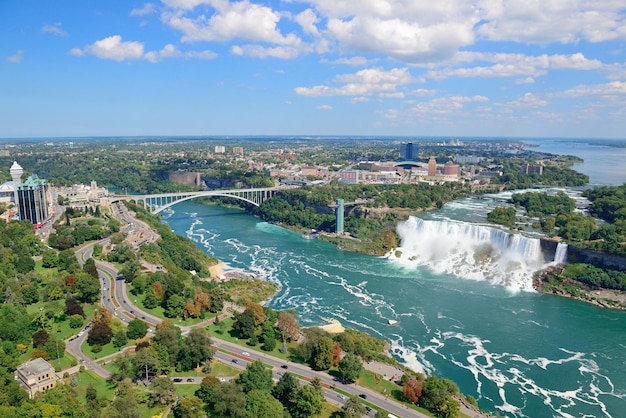 Rainbow Bridge and American Falls over river with blue sky