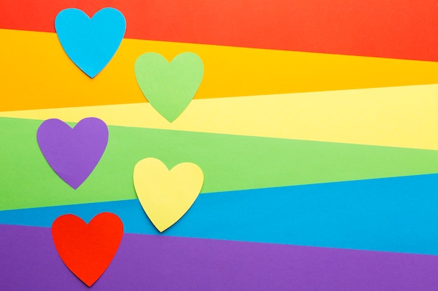 Rainbow pride flag with cutout paper hearts