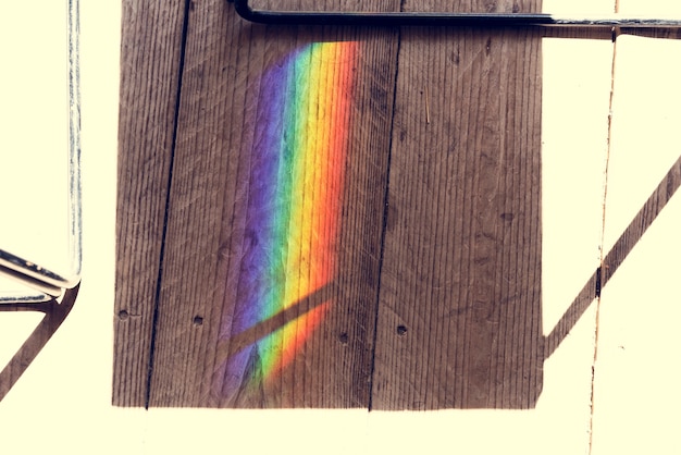 Free photo rainbow reflect on the shadow of the chair