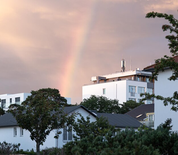 Rainbow in the sky in a residential area among houses