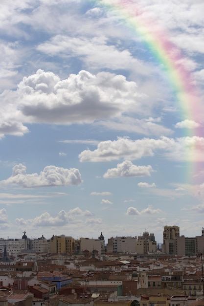 Free photo rainbow in the sky with view of the city