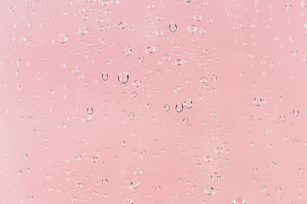 Raindrops on pink surface