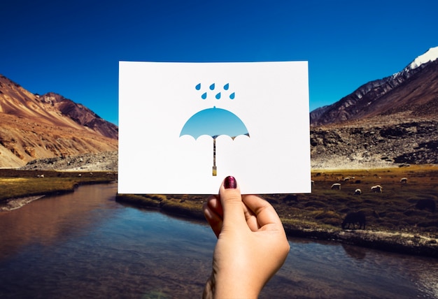 Free photo rainy season perforated paper umbrella