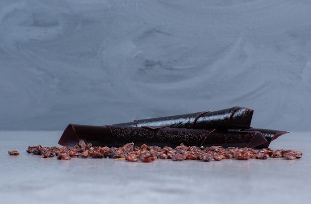 Raisins and sour cherry plum snacks on marble background. 