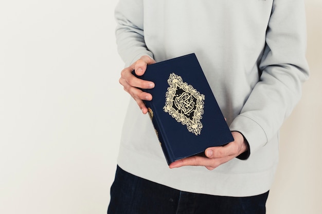 Ramadan concept with man holding quran