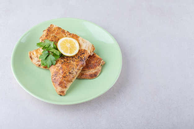 Ramadan pita with slice lemon on plate, on the marble.