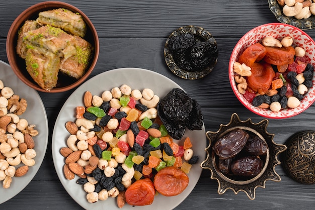 Ramadan snack with traditional dried fruits; dates and baklava on table