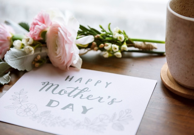 Free photo ranunculus flowers bouquet with happy mothers day wishing card