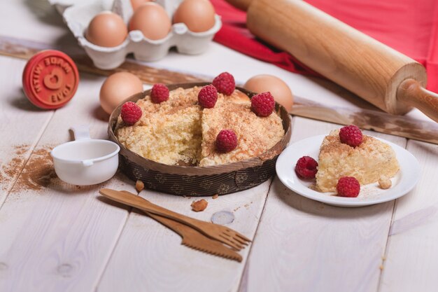 Raspberries pie on wooden plank