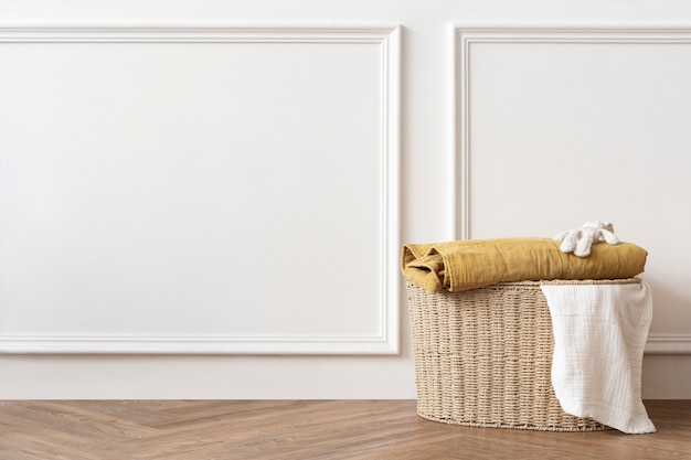 Free photo rattan laundry basket in a white room