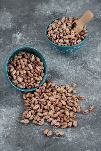 Raw bean grains displayed in bowls.