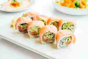 Free photo raw fresh sushi roll with wasabi in white plate