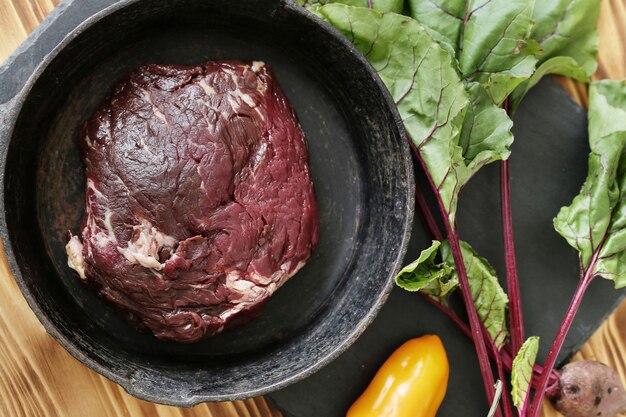 Raw meat with ingredients for cooking meal