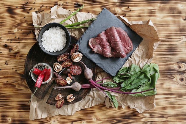 Raw meat with ingredients for cooking meal