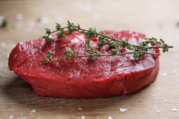 Free photo raw meat with spices and herbs on table