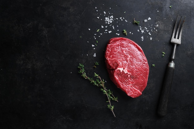 Free photo raw meat with spices and herbs on table