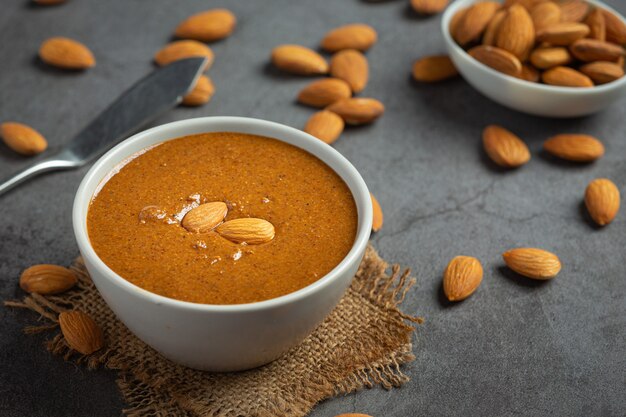 Raw Organic Almond Butter on dark background