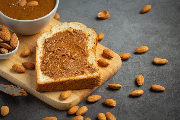 Free photo raw organic almond butter on dark background