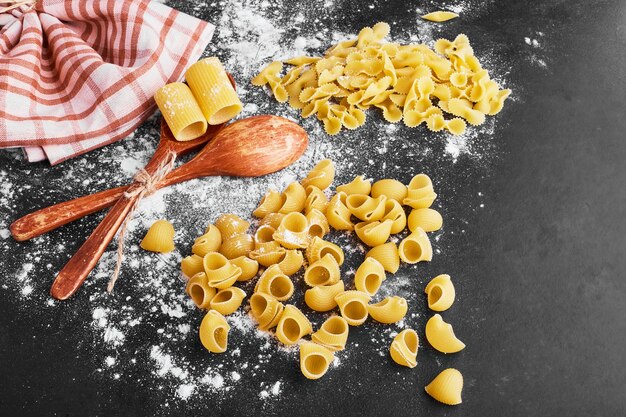 Raw pasta on a flour covered surface.