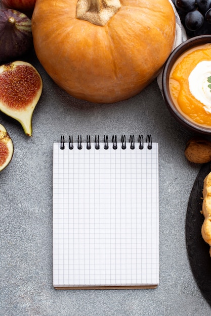 Raw pumpkin and empty notebook