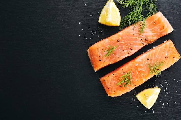 Raw salmon fish on black slate