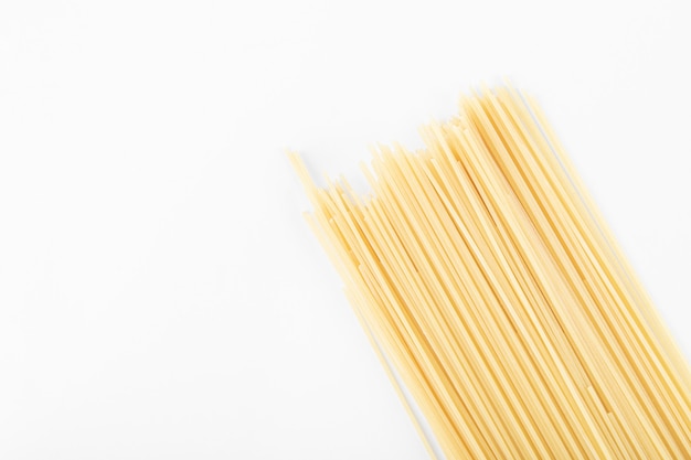 Free photo raw spaghetti pasta on white.