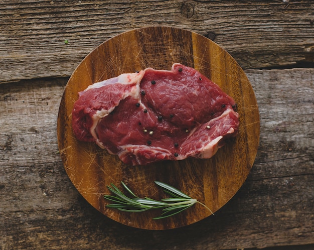 Raw steak on brown table