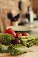 Free photo raw vegetables on wooden board