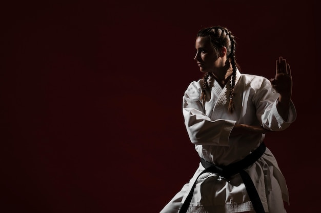 Free photo ready to fight woman in white karate uniform