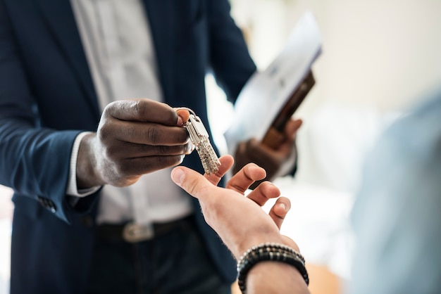 Free photo real estate agent handing the house key to a client