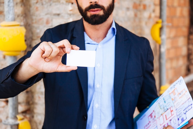 Real estate agent holding business card