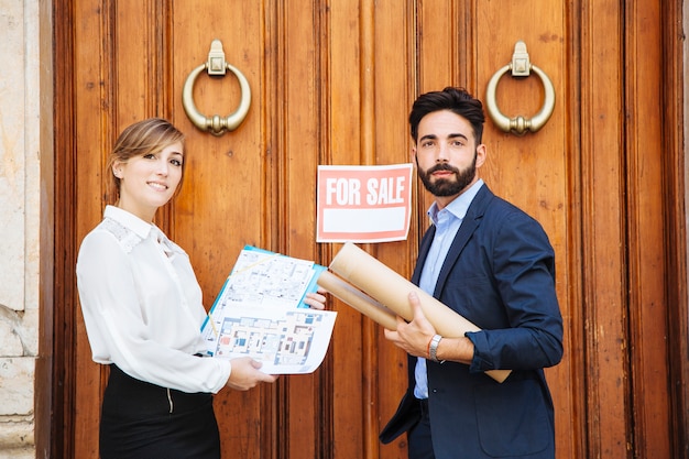 Real estate agents waiting in front of door