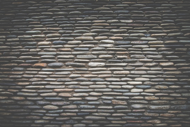 Free Photo real stone wall surface ,dark retro filter