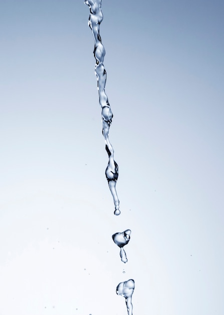 Realistic water drops on light background