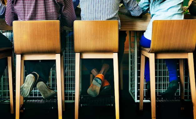 Rear view of diverse people sitting together at coffee cafe