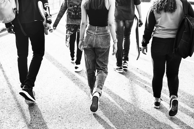 Free photo rear view of group of school friends walking outdoors lifestyle