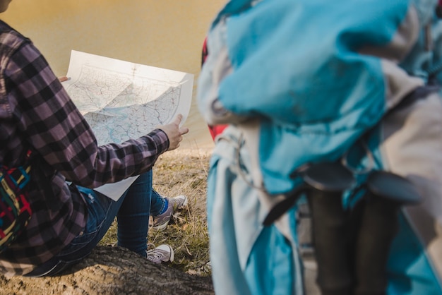 Rear view of hiker with map