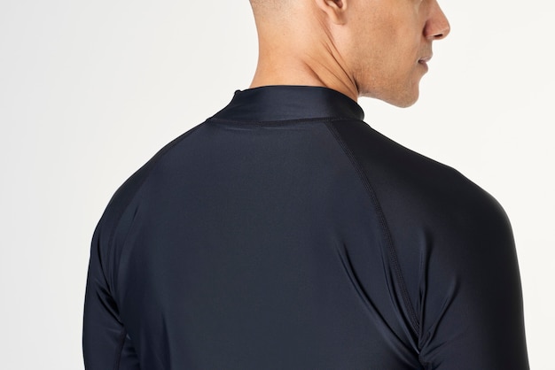 Free photo rear view of a man in a long sleeved swimming top